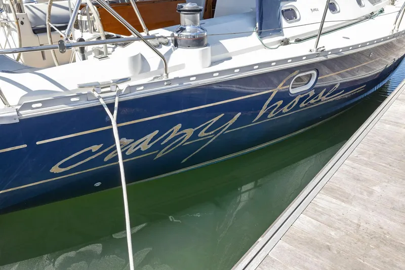 Slide: The Image of Jeanneau Sun Odyssey 52.2 sailboat, 2001 model, docked with "Crazy Horse" name on hull. - 3