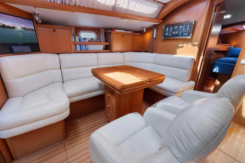 Slide: The Image of Luxurious interior of 2001 Jeanneau Sun Odyssey 52.2 yacht with plush seating and wooden accents. - 34