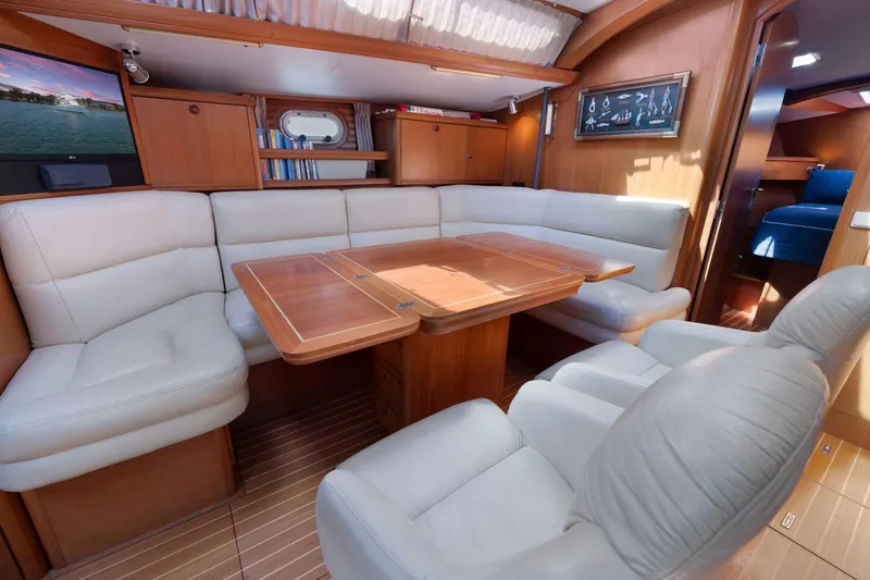 Slide: The Image of Luxurious interior of 2001 Jeanneau Sun Odyssey 52.2 yacht with plush seating and wooden table. - 35
