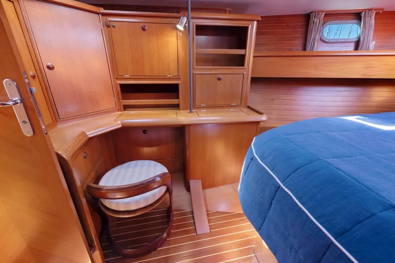 Slide: The Image of Cozy cabin interior of 2001 Jeanneau Sun Odyssey 52.2 with wooden furnishings and blue bedding. - 37