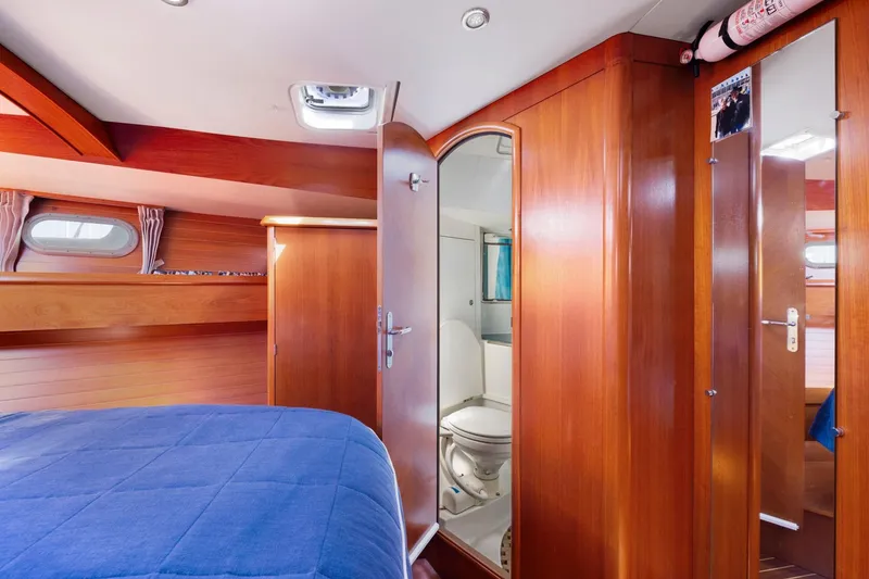Slide: The Image of Luxurious cabin interior of 2001 Jeanneau Sun Odyssey 52.2 yacht with wooden finish and ensuite bathroom. - 38