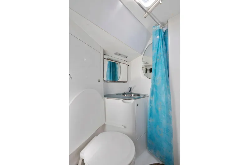 Slide: The Image of Compact bathroom in 2001 Jeanneau Sun Odyssey 52.2 yacht with blue shower curtain. - 39