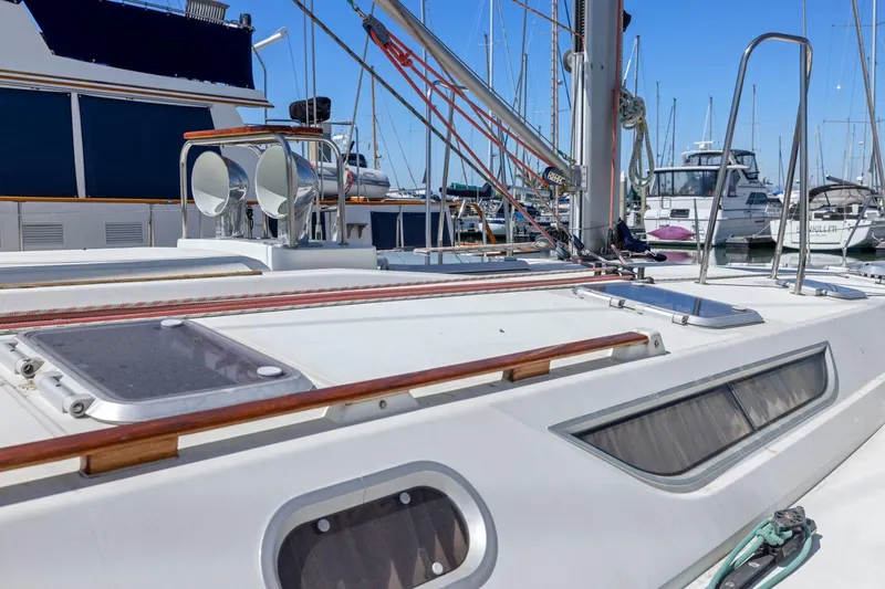 Slide: The Image of 2001 Jeanneau Sun Odyssey 52.2 sailboat deck in marina, showcasing sleek design and rigging. - 4