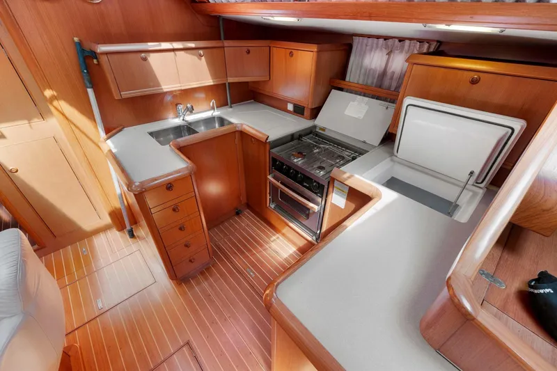 Slide: The Image of Interior of 2001 Jeanneau Sun Odyssey 52.2 yacht kitchen with wood cabinetry and appliances. - 40