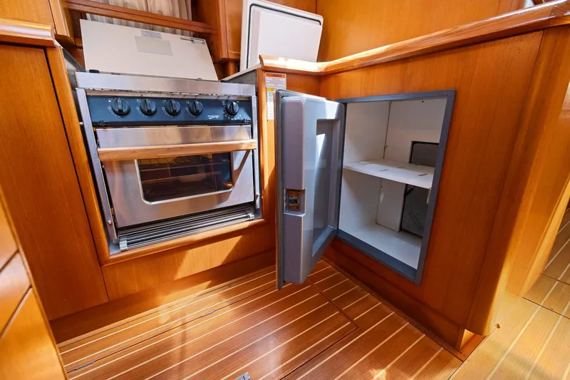 Slide: The Image of Galley kitchen in 2001 Jeanneau Sun Odyssey 52.2 yacht with oven and open fridge. - 41