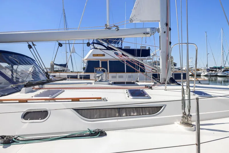 Slide: The Image of 2001 Jeanneau Sun Odyssey 52.2 sailboat docked in a marina under clear blue skies. - 5
