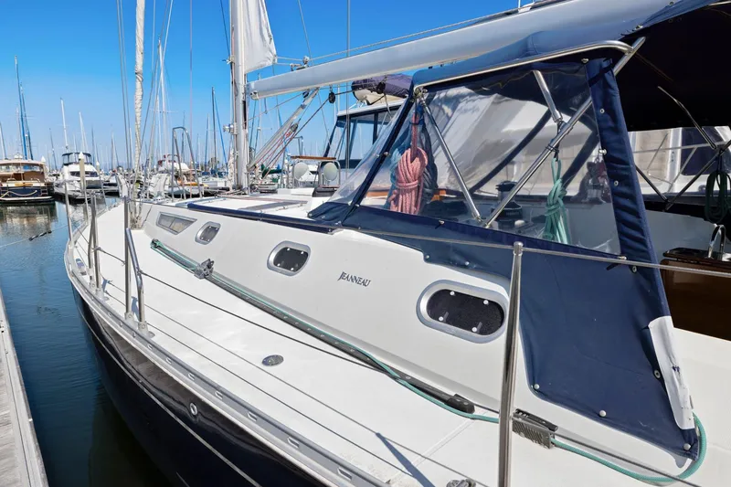 Slide: The Image of Jeanneau Sun Odyssey 52.2 sailboat docked in marina, 2001 model, blue canopy. - 6