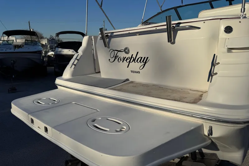 The Image of 1994 Sea Ray 270 Sundancer boat on trailer, parked outdoors under clear sky. - 0