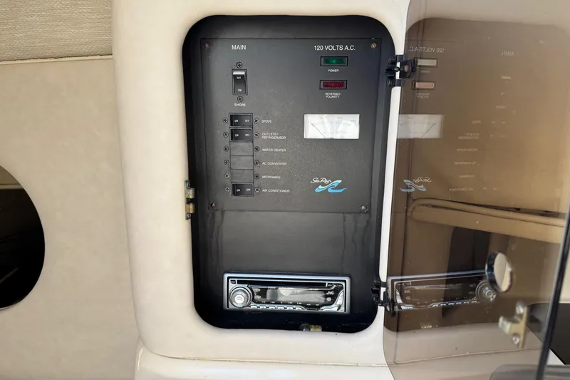 Slide: The Image of Electrical panel of 1994 Sea Ray 270 Sundancer boat, showing switches and controls. - 12