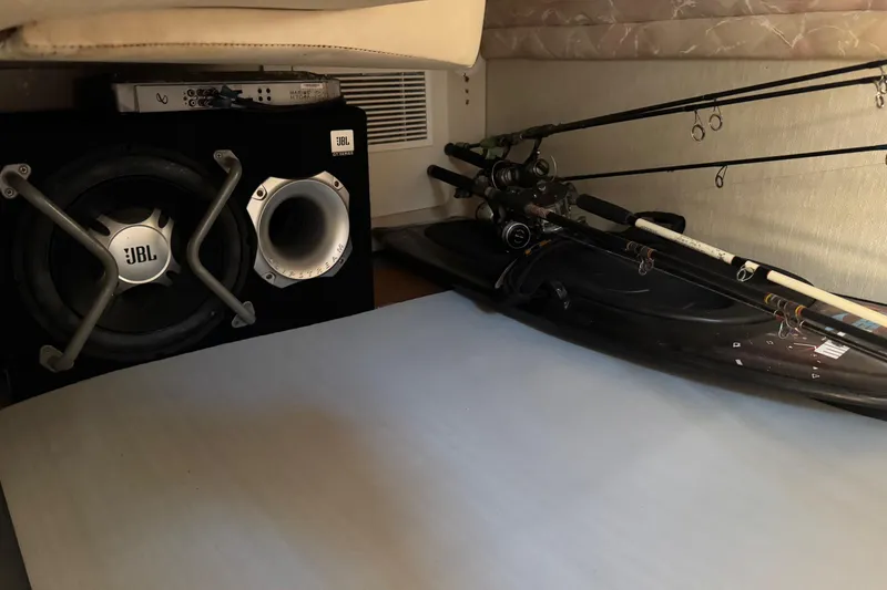 Slide: The Image of Interior of 1994 Sea Ray 270 Sundancer with JBL speaker and fishing rods. - 15