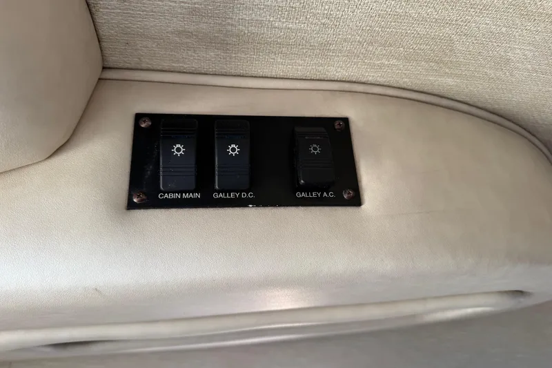 Slide: The Image of Switch panel on 1994 Sea Ray 270 Sundancer boat, featuring cabin and galley controls. - 16
