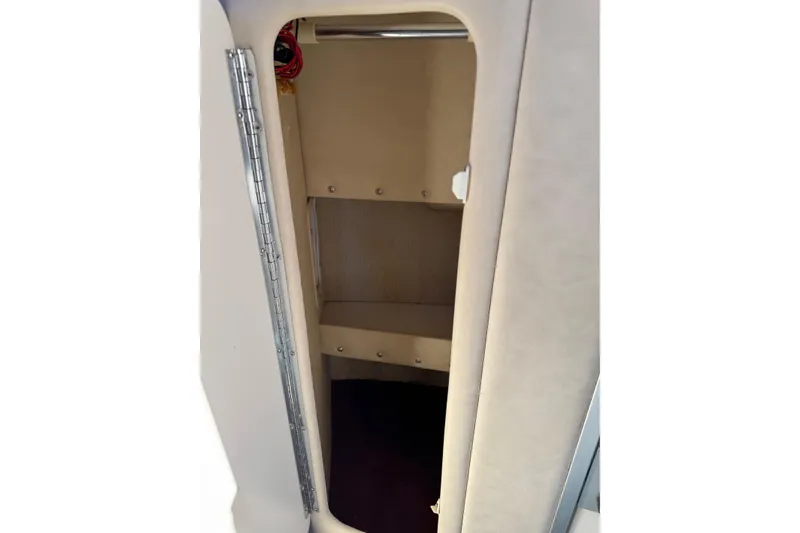 Slide: The Image of 1994 Sea Ray 270 Sundancer cabin interior with open storage compartment. - 17