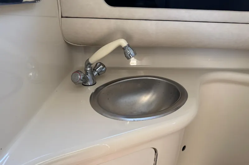 Slide: The Image of 1994 Sea Ray 270 Sundancer boat sink with faucet in cabin area. - 19