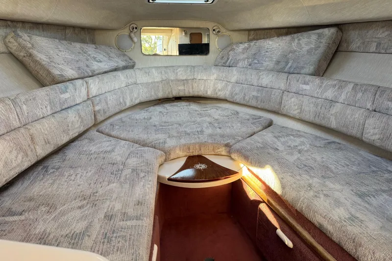 Slide: The Image of Interior cabin of 1994 Sea Ray 270 Sundancer with cushioned seating and storage. - 23