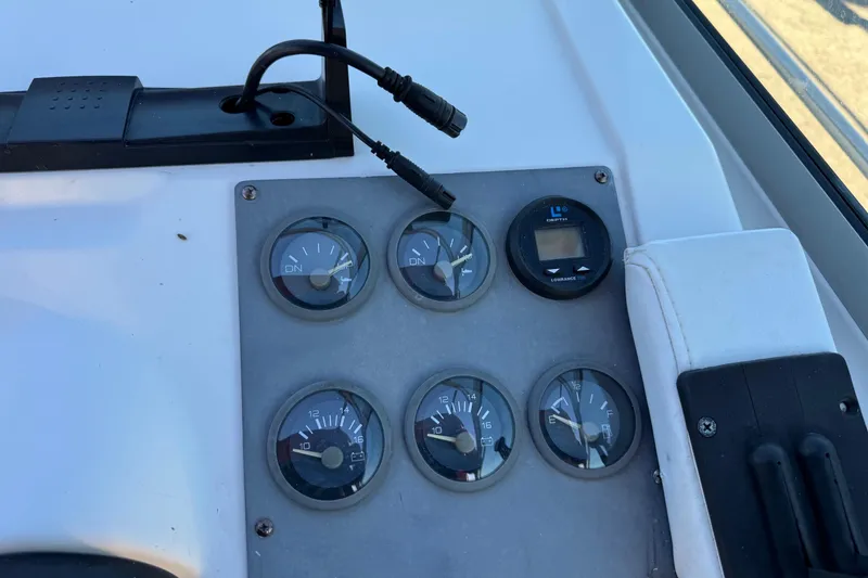 Slide: The Image of Dashboard of a 1994 Sea Ray 270 Sundancer boat with gauges and controls. - 27