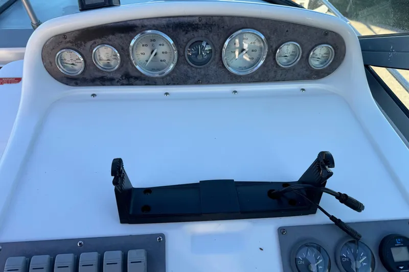 Slide: The Image of 1994 Sea Ray 270 Sundancer dashboard with gauges and controls. - 28