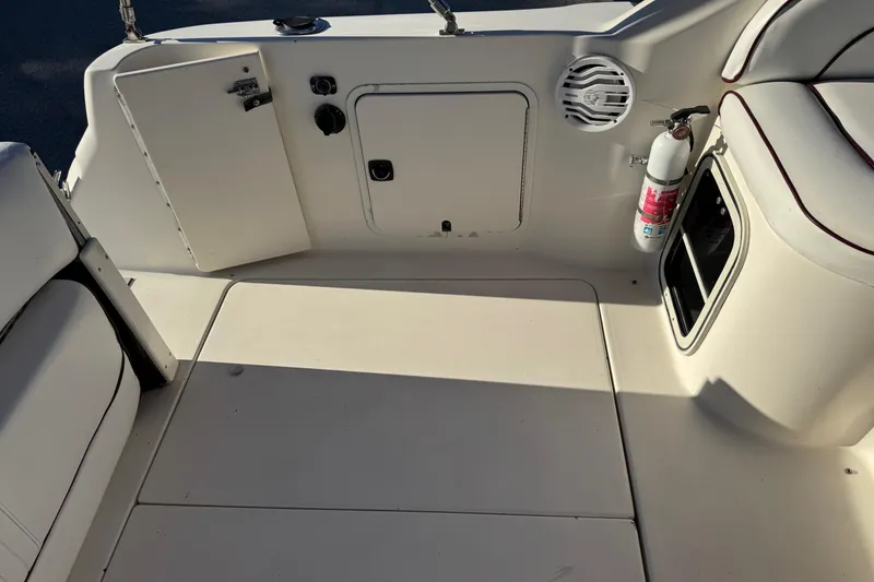 Slide: The Image of 1994 Sea Ray 270 Sundancer boat interior with seating, storage compartments, and fire extinguisher. - 33