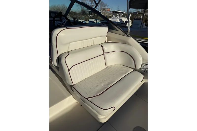 Slide: The Image of White leather seating on 1994 Sea Ray 270 Sundancer boat, featuring maroon piping. - 35