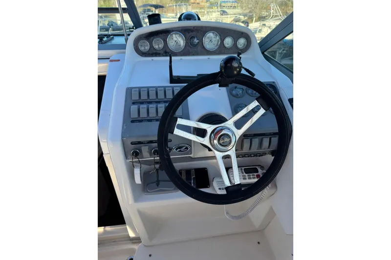 Slide: The Image of Steering console of a 1994 Sea Ray 270 Sundancer boat with gauges and controls. - 37
