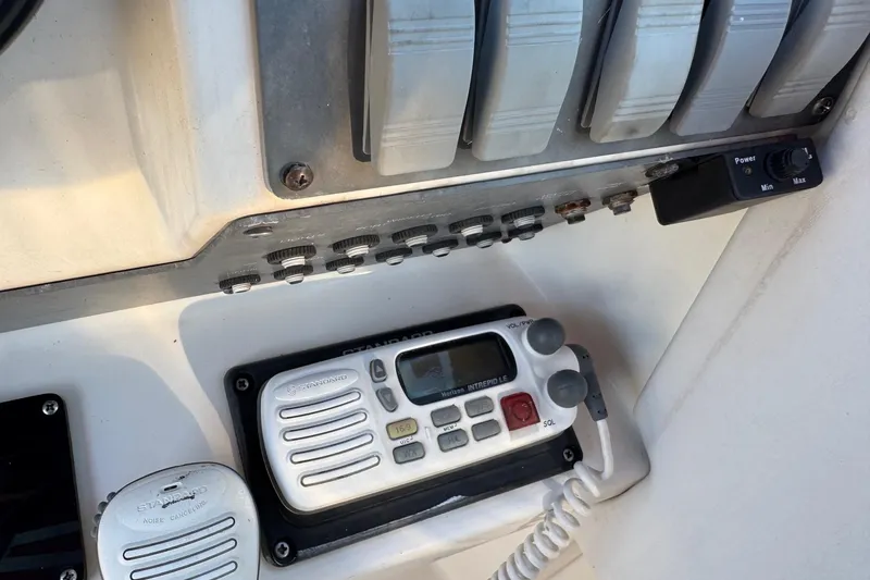 Slide: The Image of Control panel of a 1994 Sea Ray 270 Sundancer boat with radio and switches. - 38