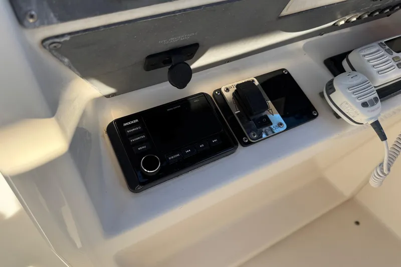 Slide: The Image of Control panel of a 1994 Sea Ray 270 Sundancer boat with radio and switches. - 6