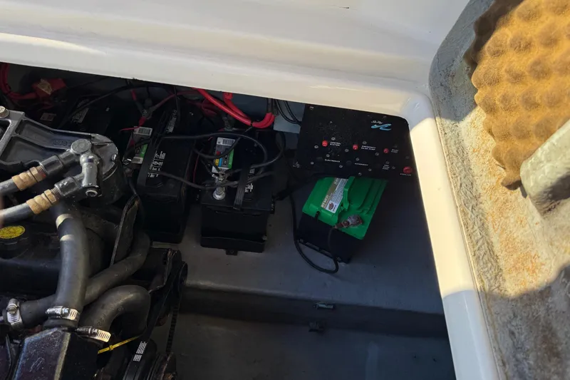 Slide: The Image of Engine compartment of a 1994 Sea Ray 270 Sundancer with visible batteries and wiring. - 8