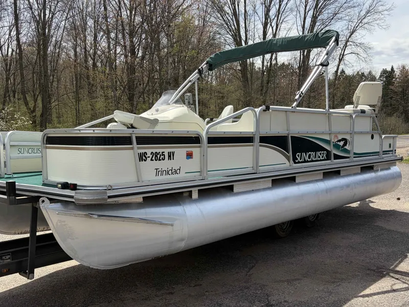The Image of 1999 Lowe Suncruiser 22 pontoon boat parked outdoors. - 1