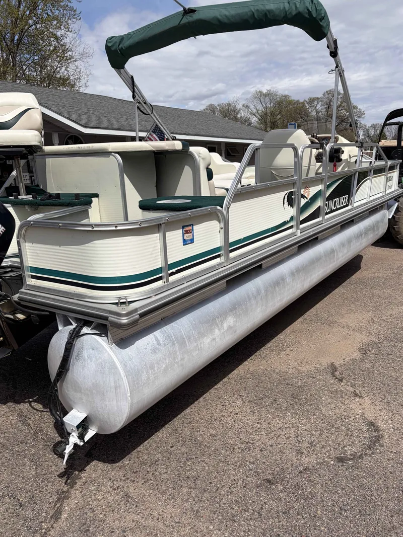 Slide: The Image of 1999 Lowe Suncruiser 22 pontoon boat parked outdoors. - 12