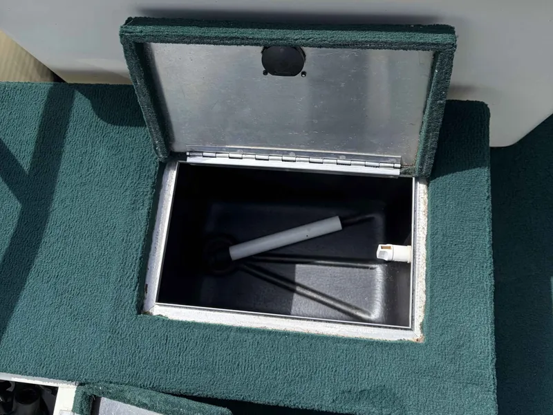 Slide: The Image of Open storage compartment on a 1999 Lowe Suncruiser 22 boat. - 4