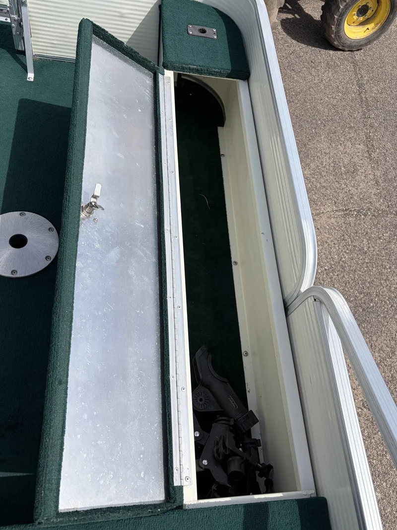 Slide: The Image of Open storage compartment on a 1999 Lowe Suncruiser 22 boat. - 5