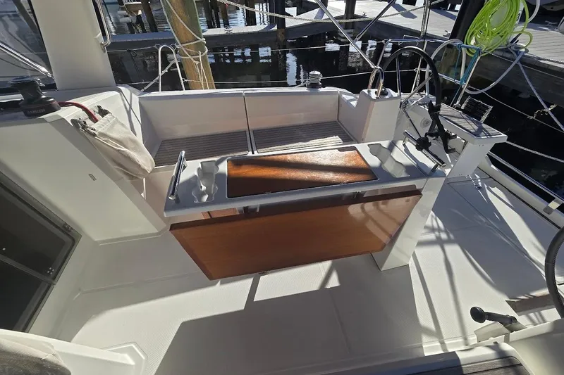 Slide: The Image of Cockpit of 2023 Beneteau Oceanis 38.1 sailboat with wooden accents and modern design. - 16