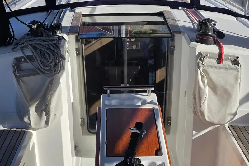 Slide: The Image of 2023 Beneteau Oceanis 38.1 cockpit with winches, ropes, and storage bags. - 18