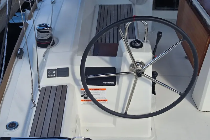 Slide: The Image of Steering wheel of 2023 Beneteau Oceanis 38.1 sailboat with Raymarine equipment. - 19