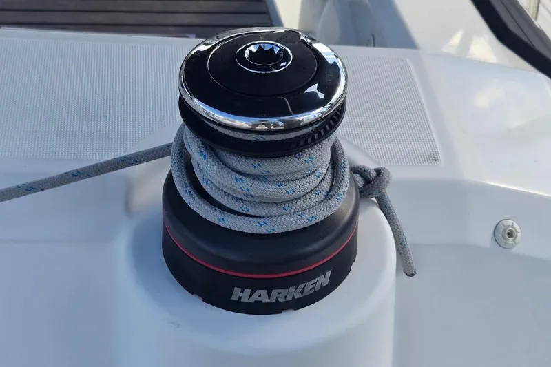 Slide: The Image of Winch on 2023 Beneteau Oceanis 38.1 sailboat with Harken branding and coiled rope. - 27