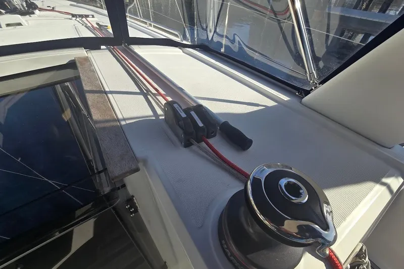 Slide: The Image of 2023 Beneteau Oceanis 38.1 yacht deck with winch and red rope. - 32