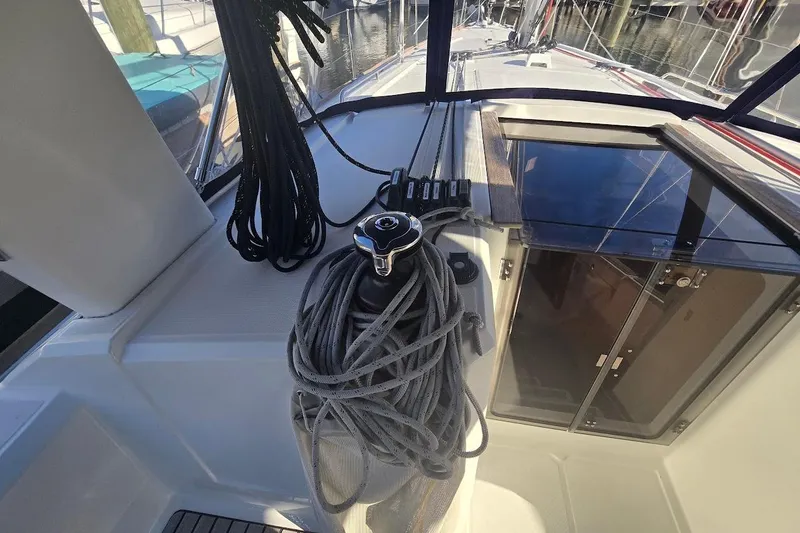 Slide: The Image of 2023 Beneteau Oceanis 38.1 sailboat cockpit with ropes and winch. - 34