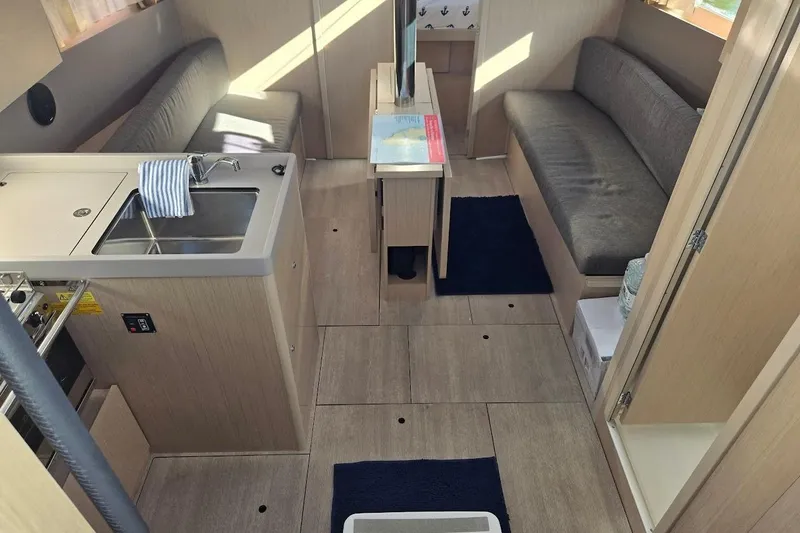 Slide: The Image of 2023 Beneteau Oceanis 38.1 interior with modern kitchen and seating area. - 37