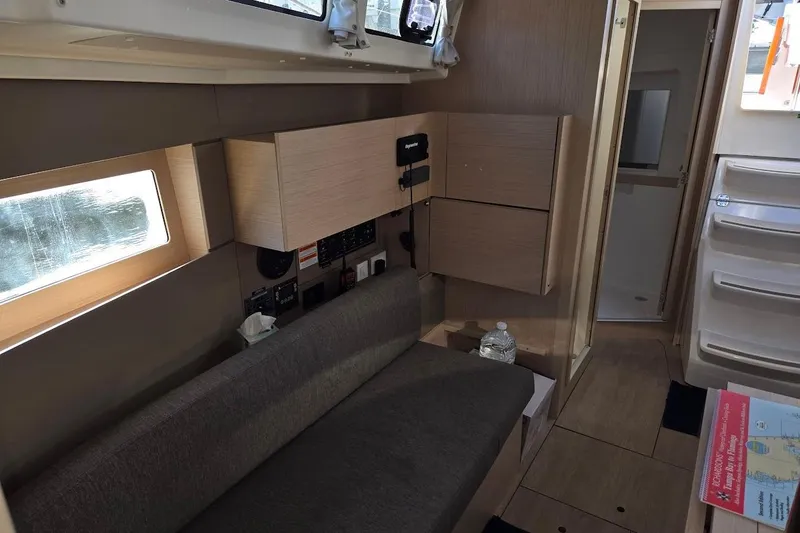 Slide: The Image of Interior of 2023 Beneteau Oceanis 38.1 yacht, featuring modern seating and cabinetry. - 40