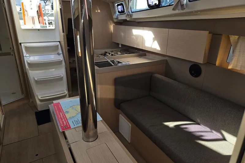 Slide: The Image of Interior of 2023 Beneteau Oceanis 38.1 yacht, featuring modern kitchen and seating area. - 41