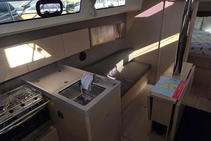 Slide: The Image of Modern interior of 2023 Beneteau Oceanis 38.1 yacht with kitchen and seating area. - 46