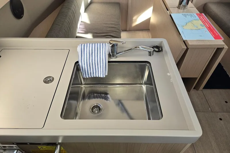 Slide: The Image of Modern kitchen sink in 2023 Beneteau Oceanis 38.1 yacht interior. - 48