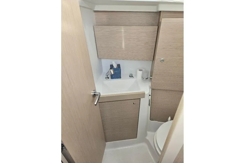Slide: The Image of Compact bathroom in 2023 Beneteau Oceanis 38.1 yacht with sink and toilet. - 56