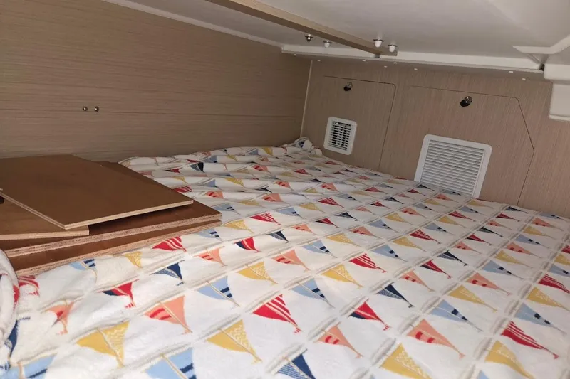 Slide: The Image of Cozy cabin interior of 2023 Beneteau Oceanis 38.1 with colorful patterned bedding. - 61