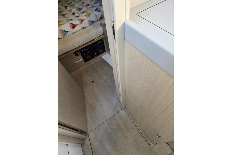 Slide: The Image of Interior view of 2023 Beneteau Oceanis 38.1 yacht, featuring cabin and control panel. - 62