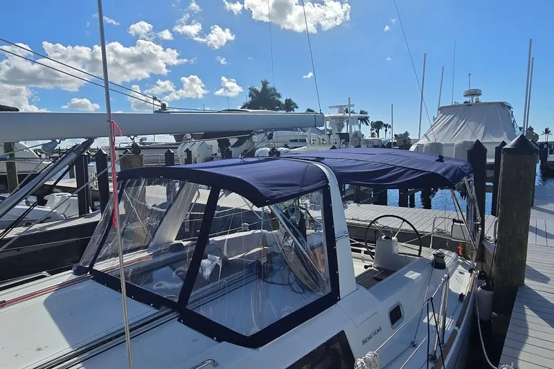 Slide: The Image of 2023 Beneteau Oceanis 38.1 sailboat docked at marina under clear blue sky. - 64
