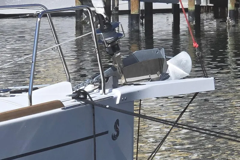 Slide: The Image of 2023 Beneteau Oceanis 38.1 yacht bow with anchor and railing, docked in calm waters. - 71