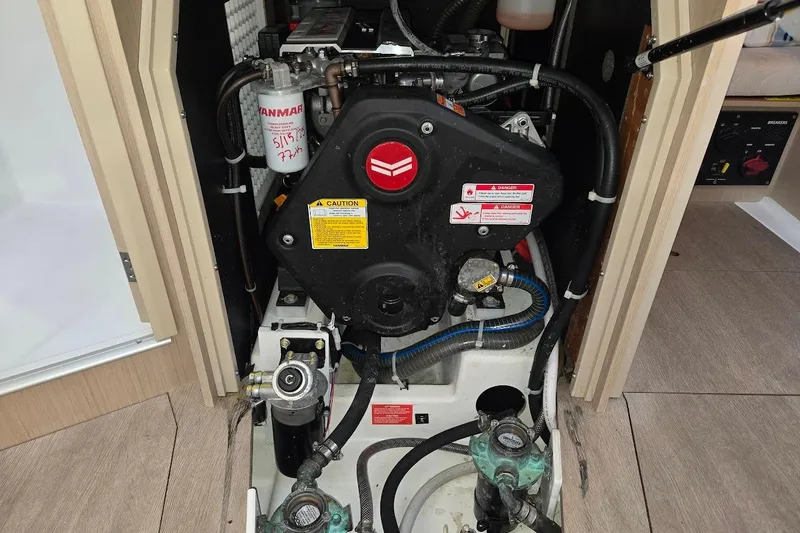 Slide: The Image of Engine compartment of 2023 Beneteau Oceanis 38.1 sailboat, featuring Yanmar engine components. - 82
