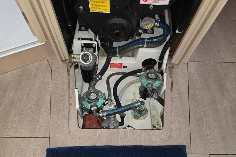 Slide: The Image of Engine compartment of 2023 Beneteau Oceanis 38.1 sailboat, showcasing mechanical components. - 84