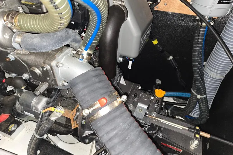 Slide: The Image of Engine compartment of a 2023 Beneteau Oceanis 38.1 sailboat, showcasing hoses and mechanical components. - 88