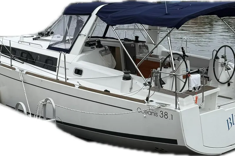 Slide: The Image of 2023 Beneteau Oceanis 38.1 sailboat with blue canopy docked at marina. - 91
